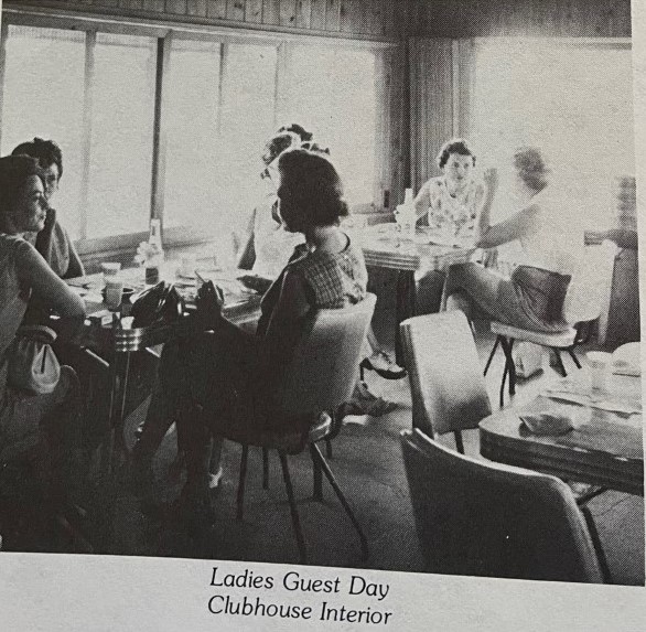 Ladies at the clubhouse golf course eating at tables.