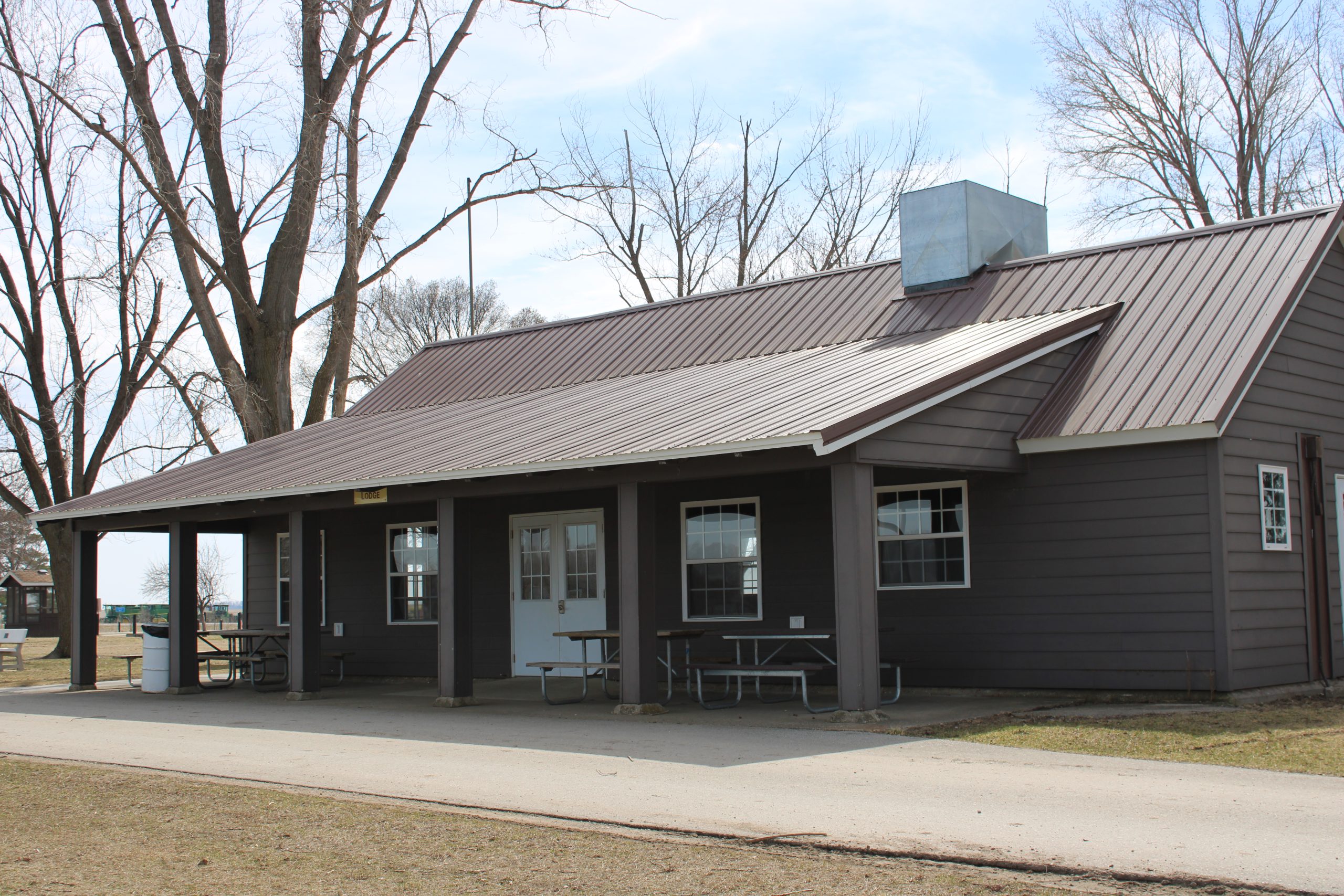 Outside view of the Lodge at Mill Creek Park. Brown paint with large overhang porch.