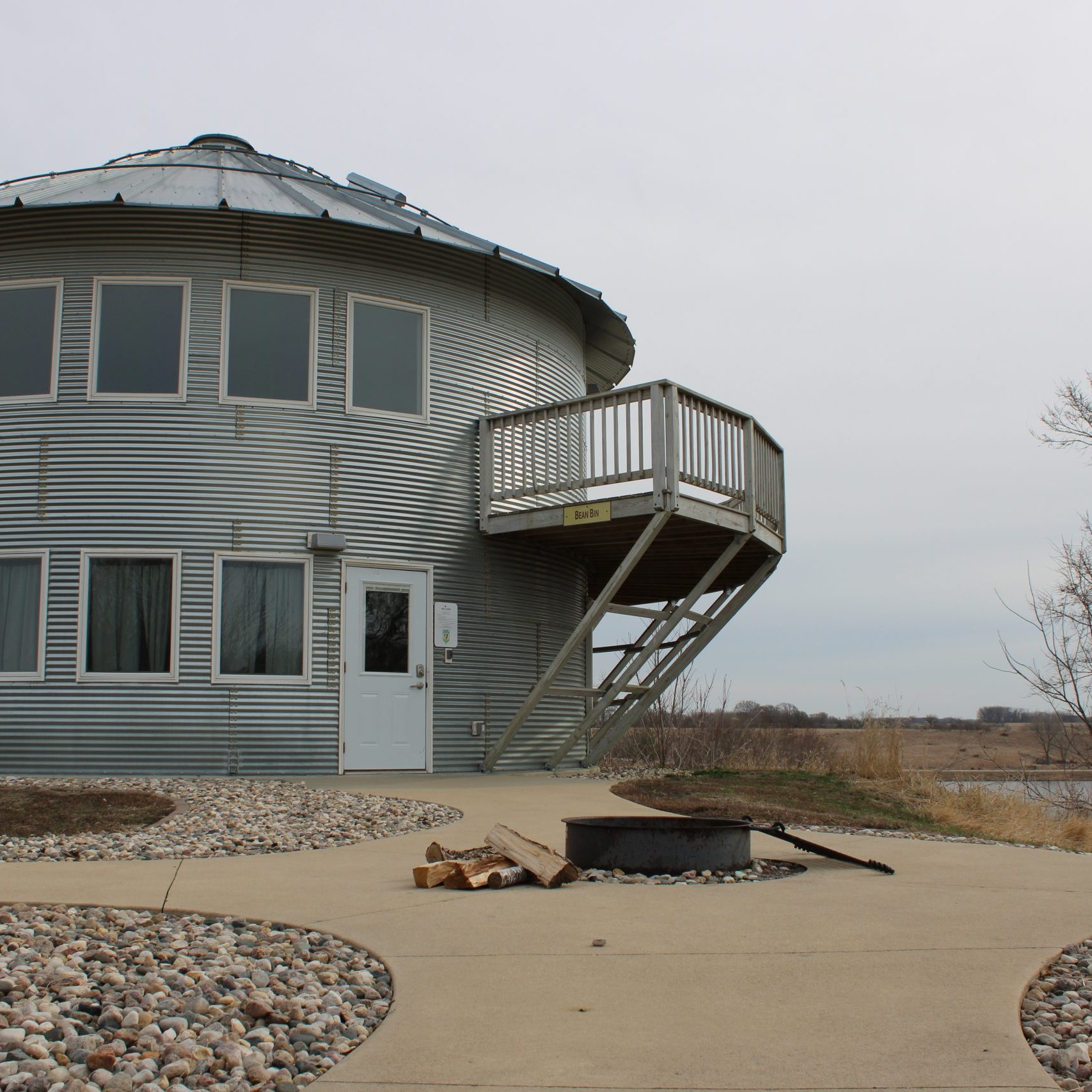 Exterior of the Grain Bin cabin with windows, door and deck.